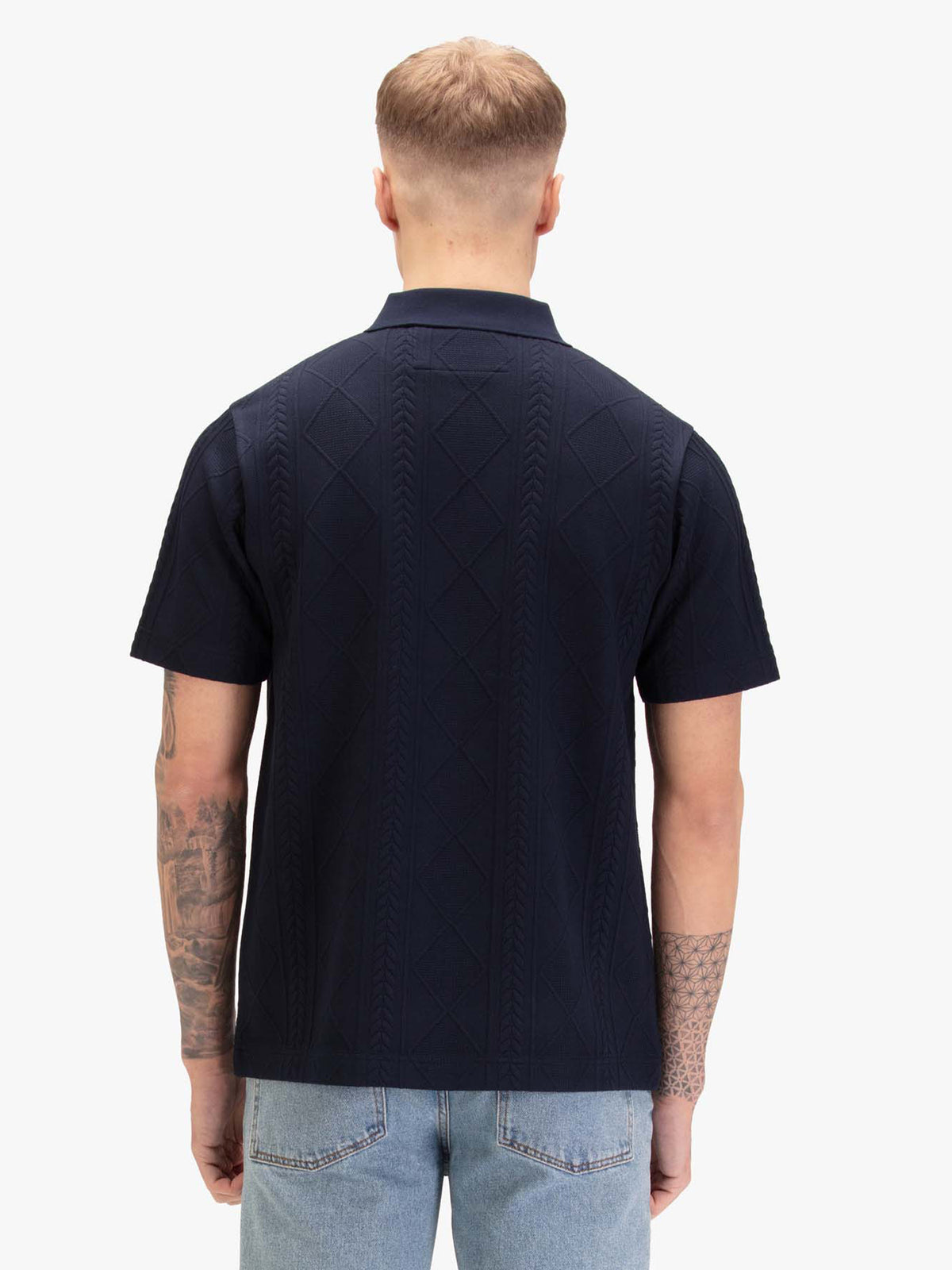 Men's navy polo shirt with polo collar, worn by a model, back view