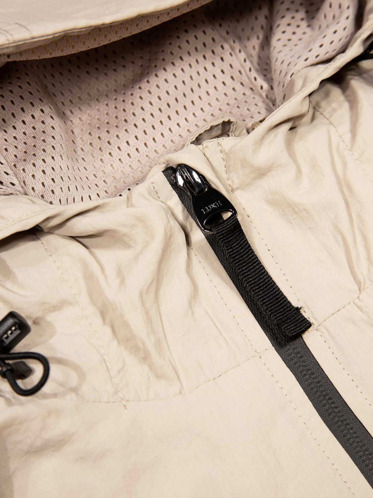 Men's beige jacket with chest pocket, detail view