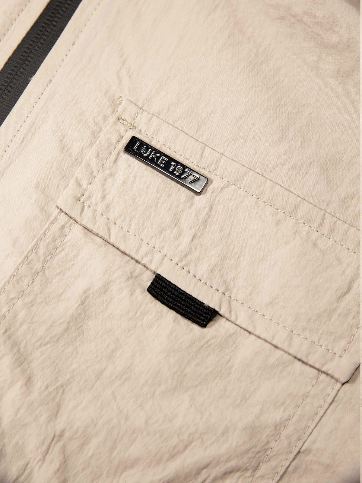 Men's beige jacket with chest pocket.