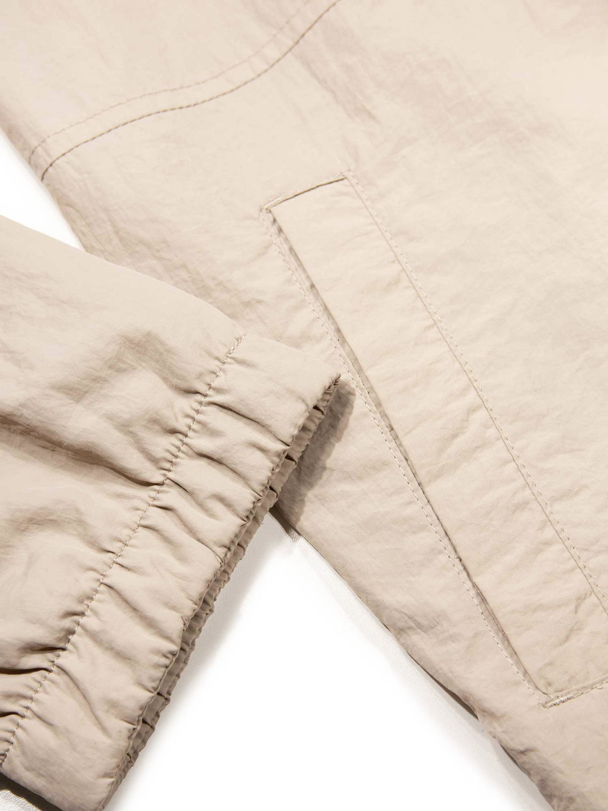 Men's beige jacket with chest pocket.