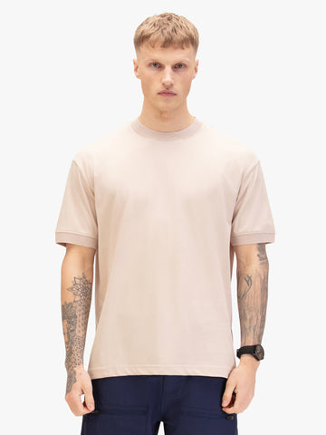 Men's beige t-shirt with crew neck and short sleeves worn by a model - front view.