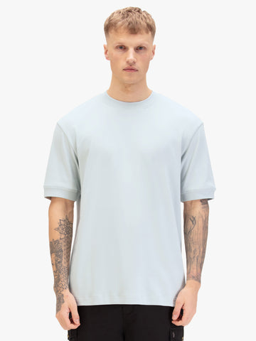 Men's relaxed-fit blue t-shirt with crew neck and short sleeves, worn by a model, front view