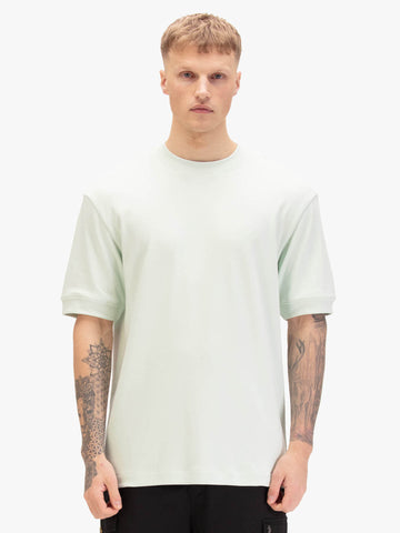 Men's relaxed-fit green t-shirt with crew neck and short sleeves, worn by a model, front view