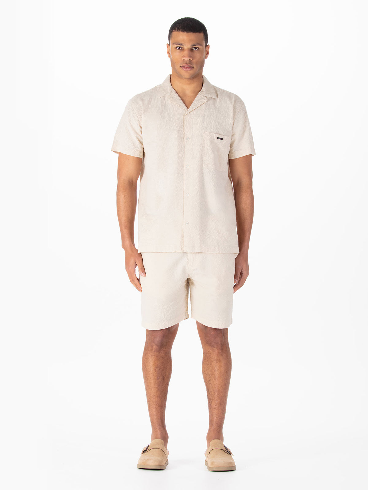 Men's beige short set with short-sleeve shirt and matching shorts.
