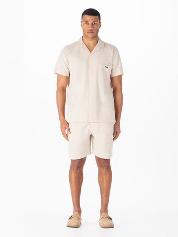 Men's beige short set with short-sleeve shirt and matching shorts.