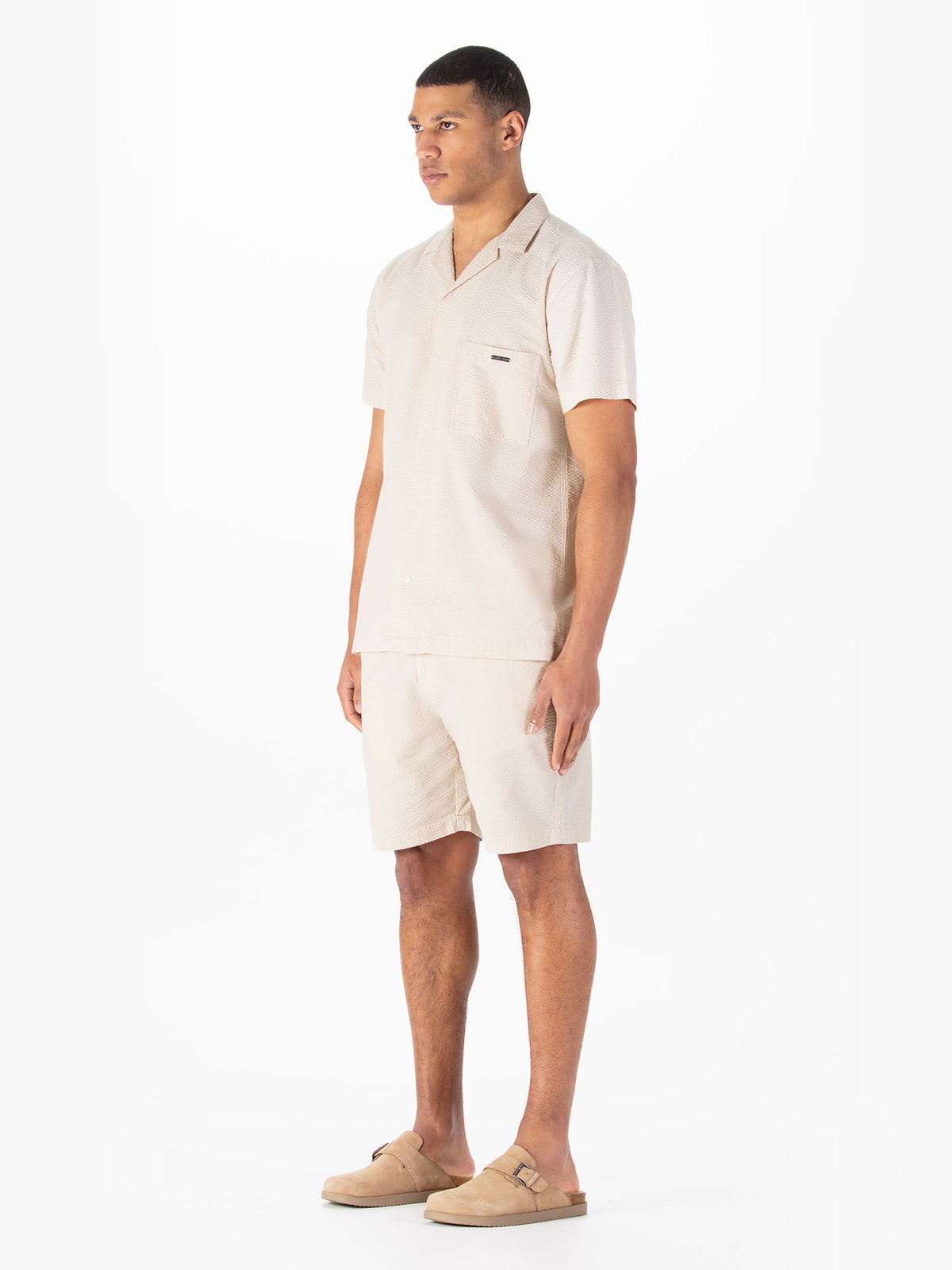 Men's beige short set with short-sleeve shirt and matching shorts.