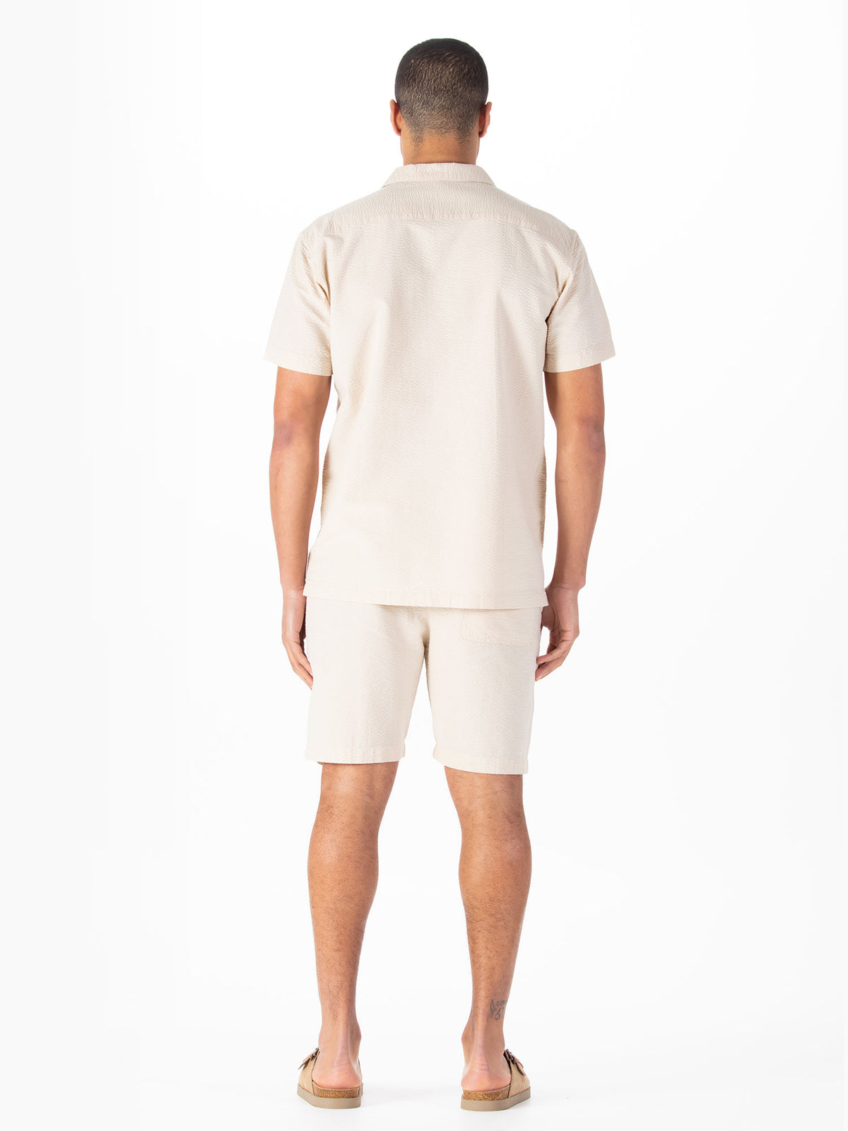 Men's beige short set with short-sleeve shirt and matching shorts.