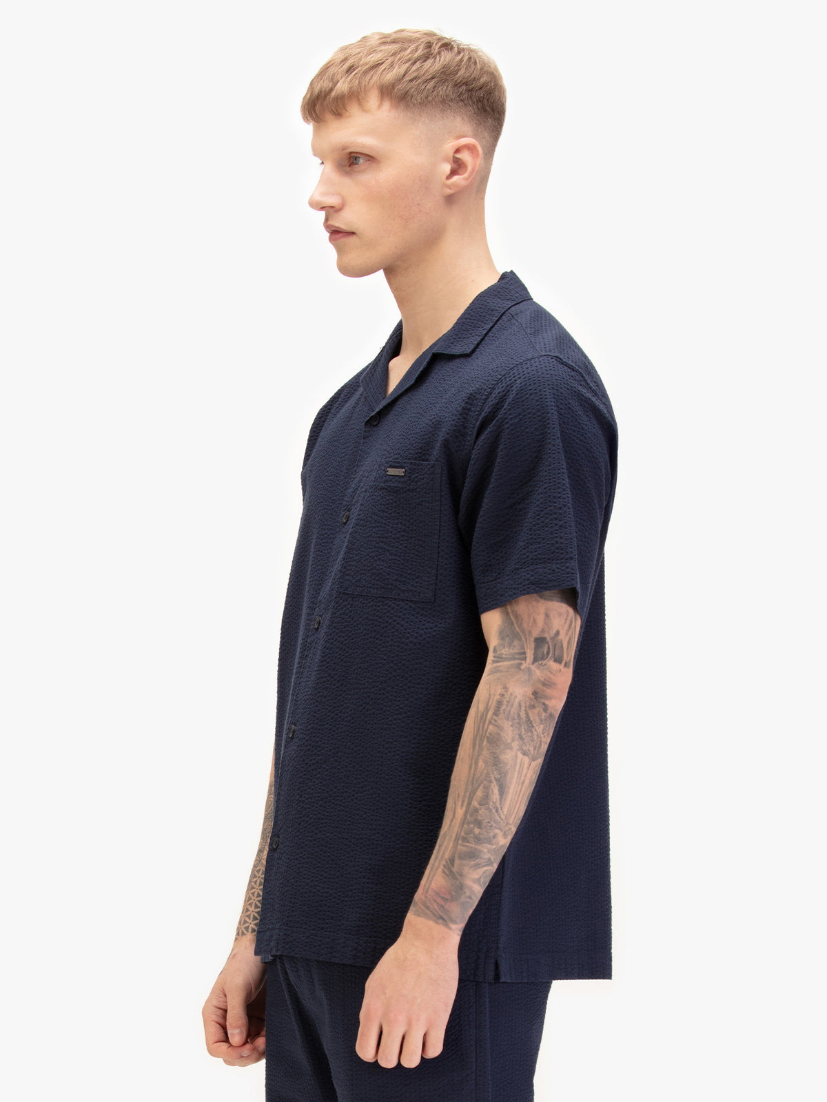 Men's navy shirt with button-up front, back view