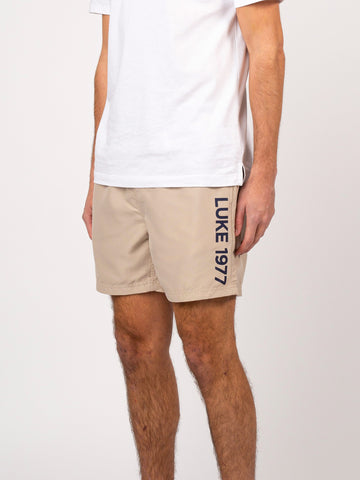 Men's beige swim shorts with drawstring waistband.