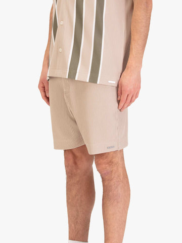 Men's beige shorts with drawstring waistband, worn by a model, side view