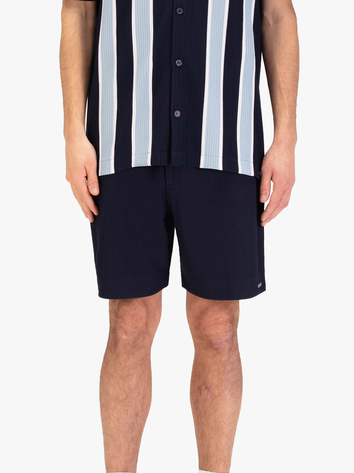Men's navy shorts with drawstring waistband, worn by a model, front view