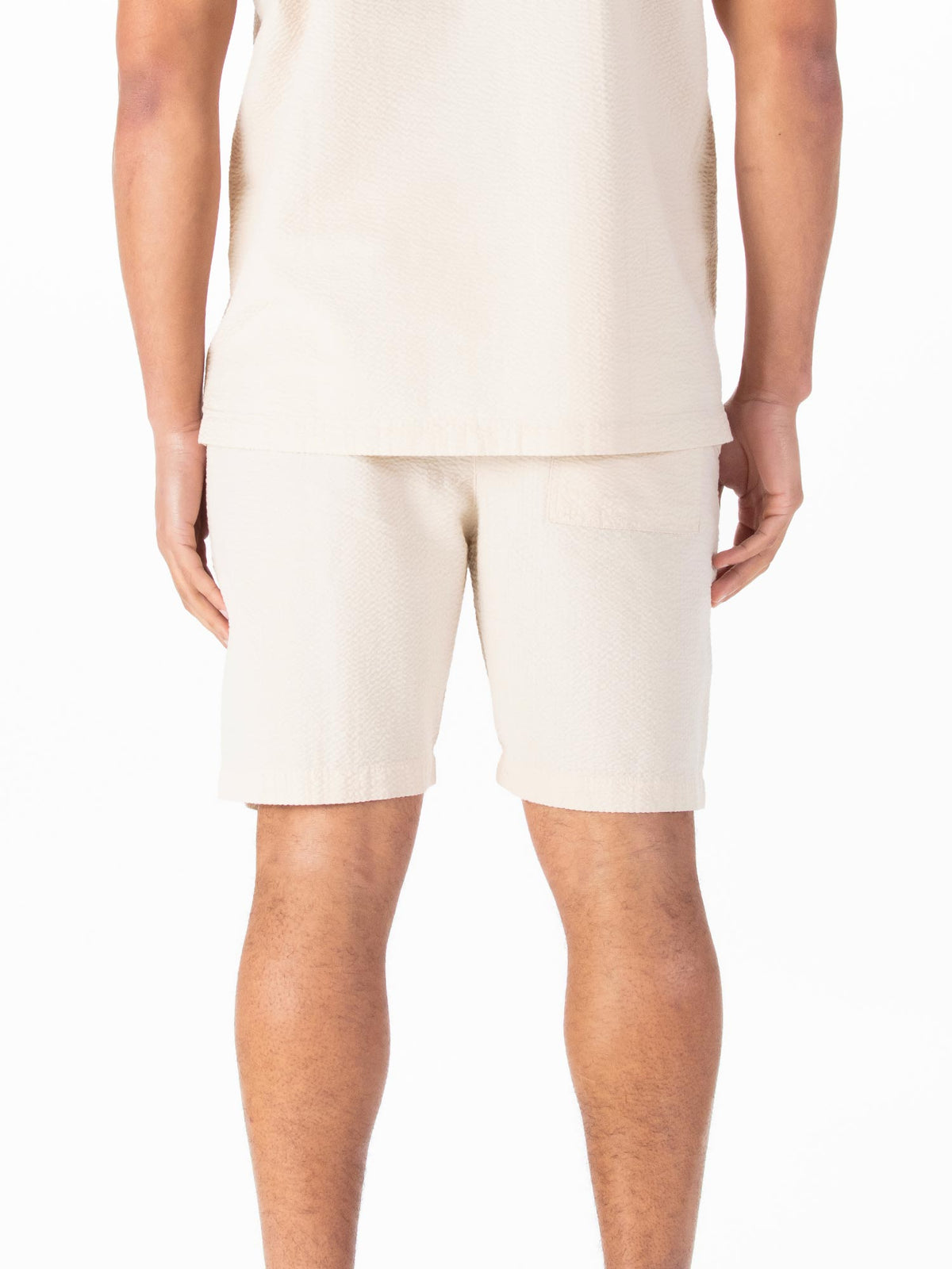 Men's beige shorts with drawstring waistband.