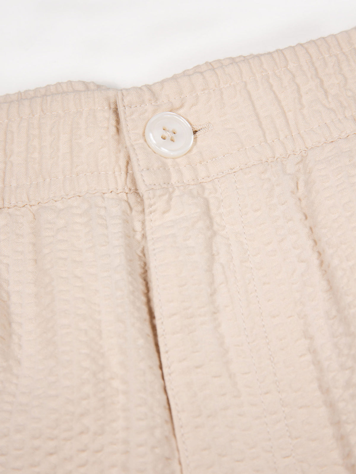 Men's beige shorts with drawstring waistband.