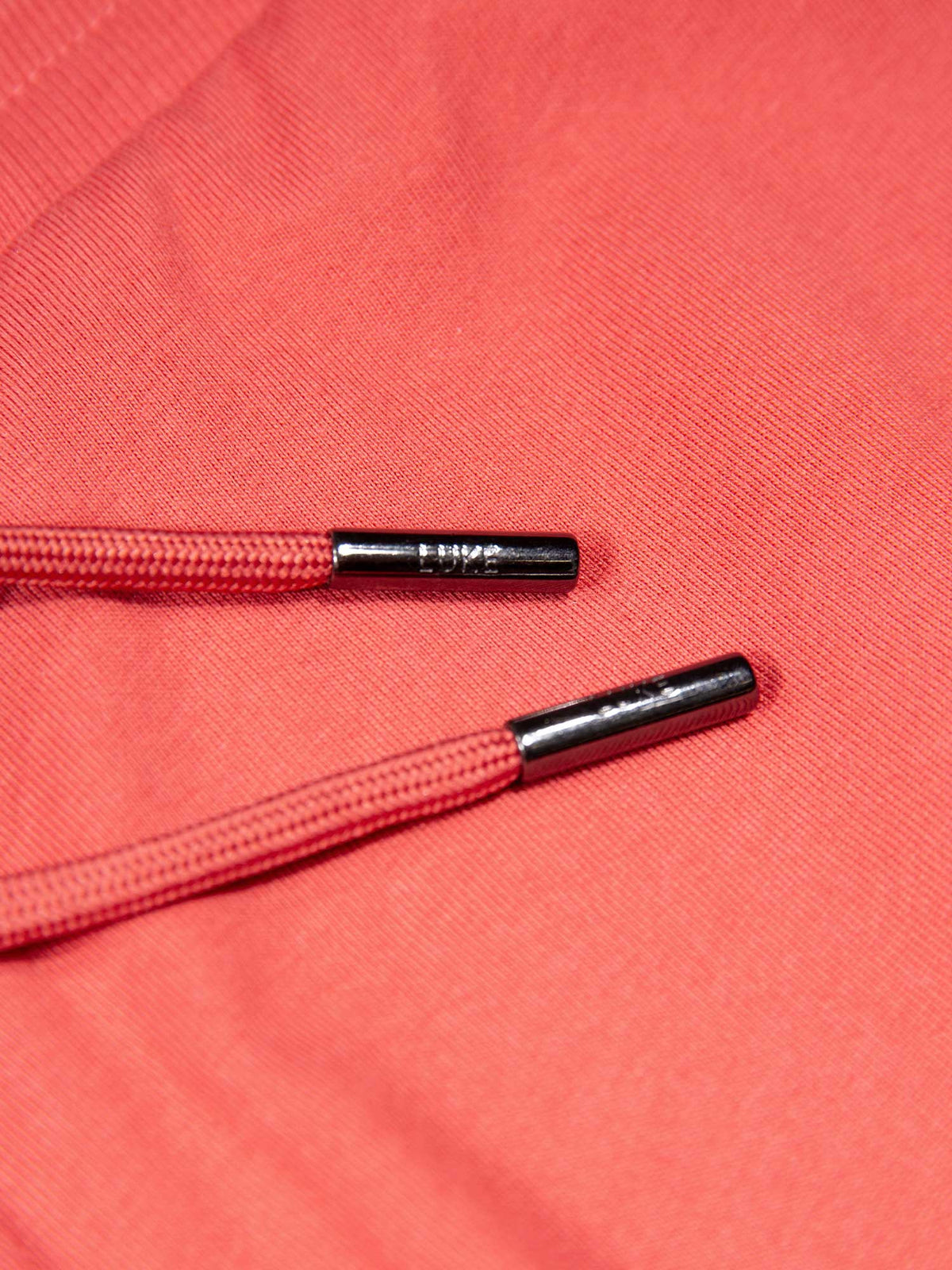 Men's red short set with short-sleeve shirt and drawstring shorts, detail view.