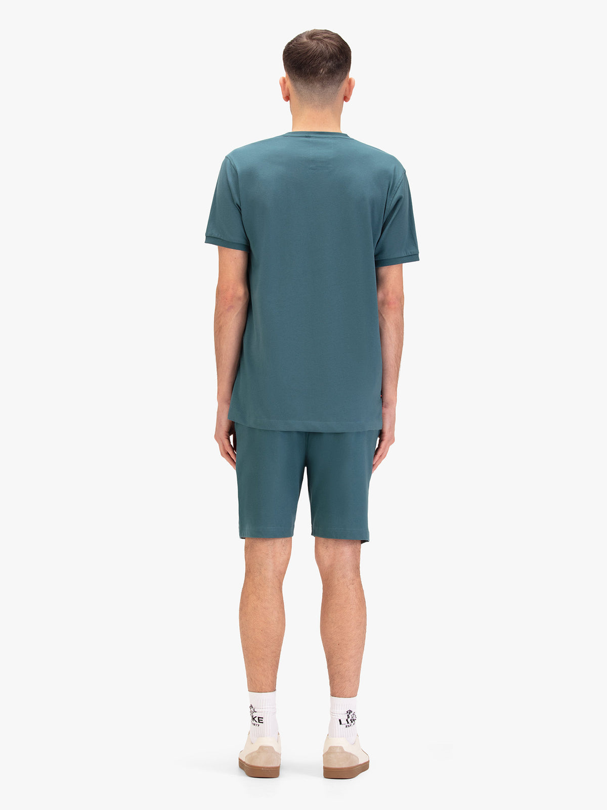 Men's blue short set with short-sleeve shirt and drawstring shorts, worn by a model, back view.