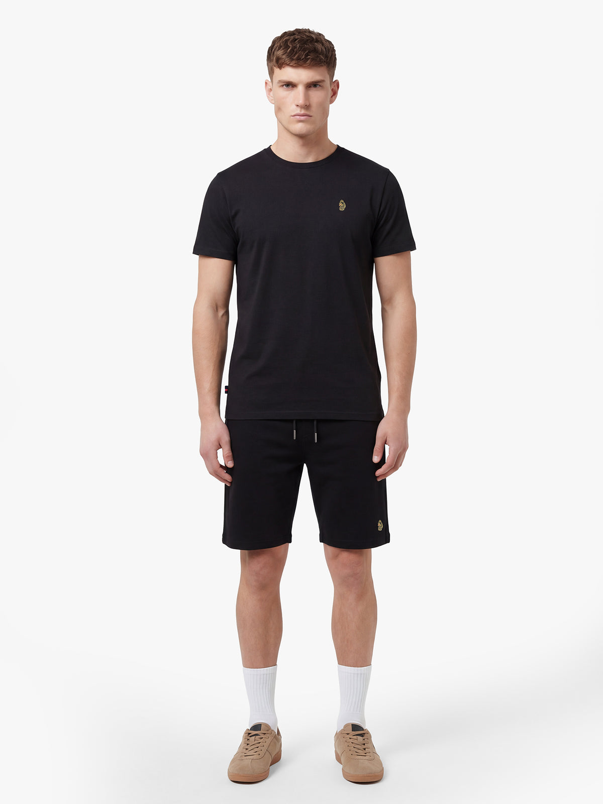 Men's black short set with short-sleeve shirt and drawstring shorts, worn by model.