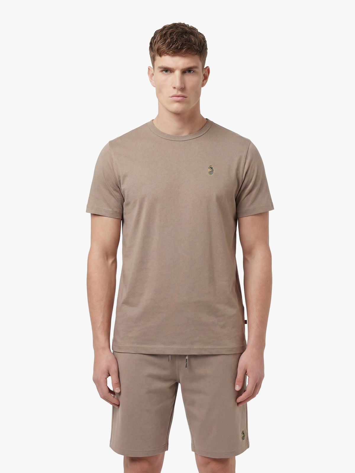 Men's brown short set with short-sleeve shirt and drawstring shorts, worn by a model, front view.
