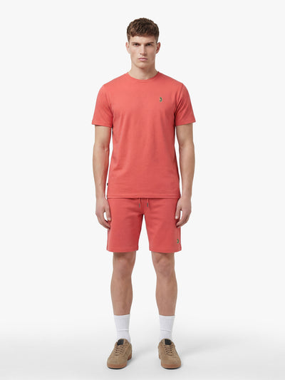Men's red short set with short-sleeve shirt and drawstring shorts, worn by model.