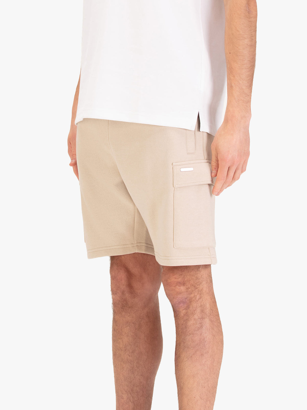 Men's beige shorts with elasticated waistband and cargo pockets, worn by a model, side view