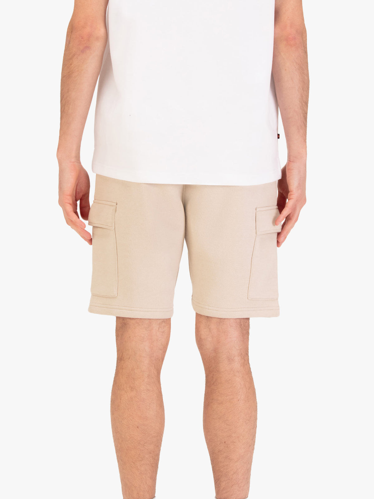 Men's beige shorts with elasticated waistband and cargo pockets, worn by a model, back view