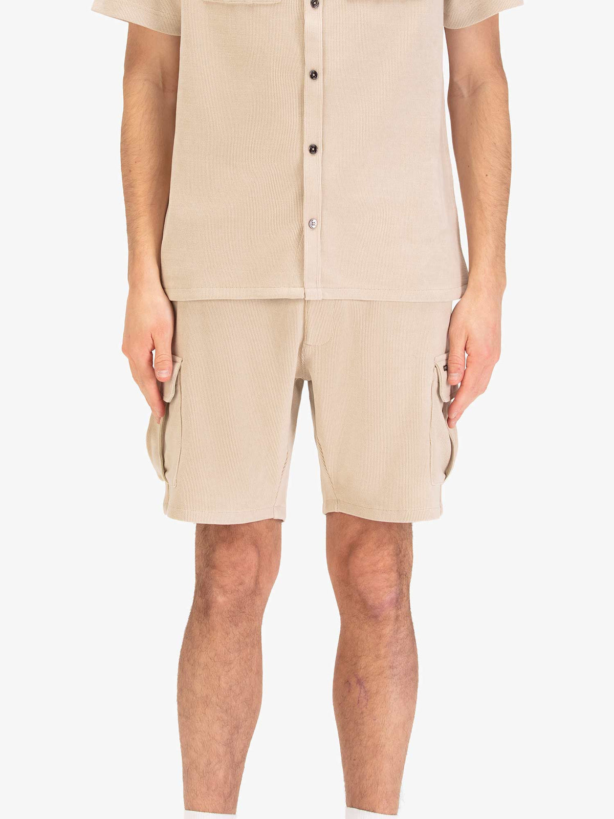 Men's beige shorts with drawstring waistband and cargo pockets, worn by a model, front view