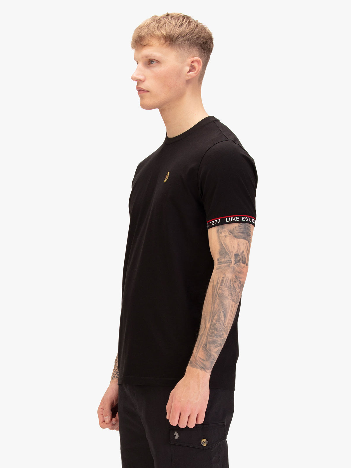 Men's black t-shirt with crew neck and short sleeves, worn by a model, side view