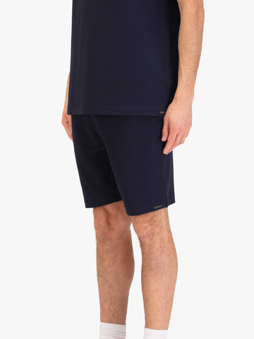 Men's navy shorts with drawstring waistband, worn by a model, side view