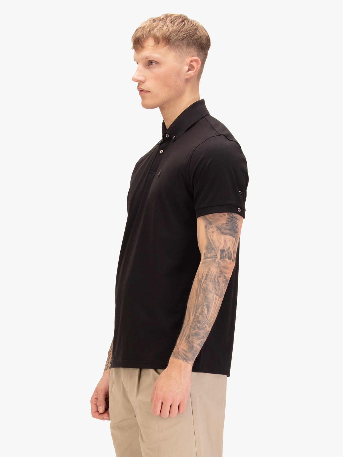 Side view of man wearing black LUKE 1977 Macau premium modal polo shirt