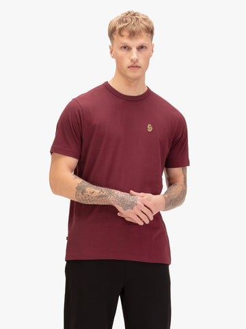 Men's red t-shirt with crew neck and short sleeves, worn by a model, front view