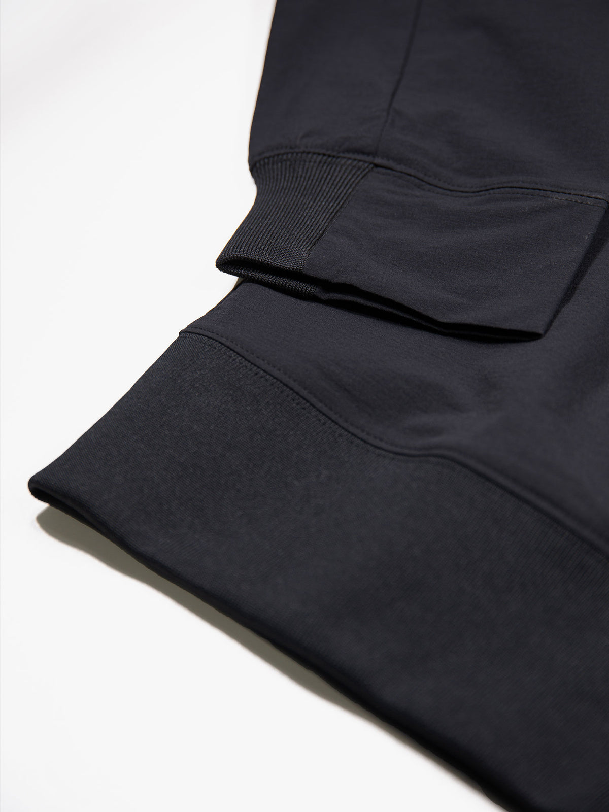 Boy's black sweatshirt with concealed zip and sleeve pocket, logo detail view