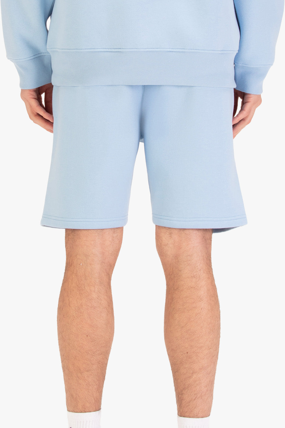 Men's blue shorts with drawstring waistband, worn by a model, back view