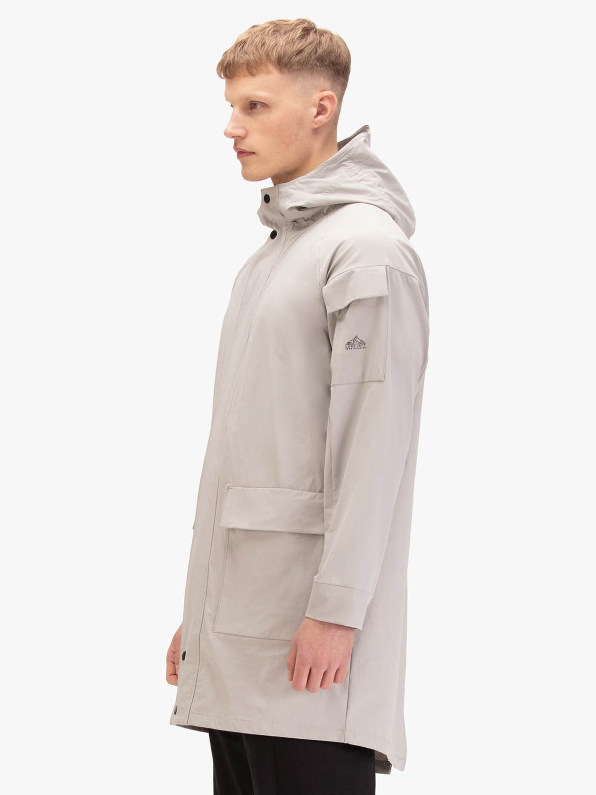 Men's grey jacket with zip-up front, worn by a model, side view