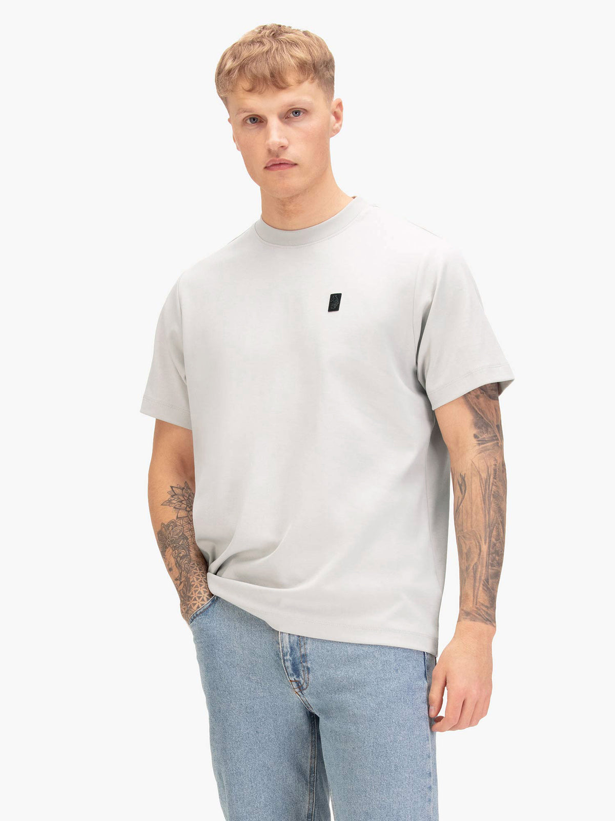Men's relaxed-fit grey t-shirt with crew neck and short sleeves, worn by a model, front view