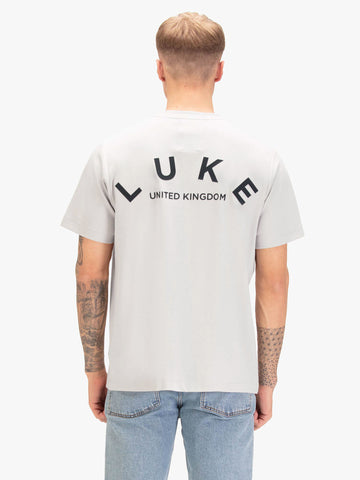 Men's relaxed-fit grey t-shirt with crew neck and short sleeves, worn by a model, back view
