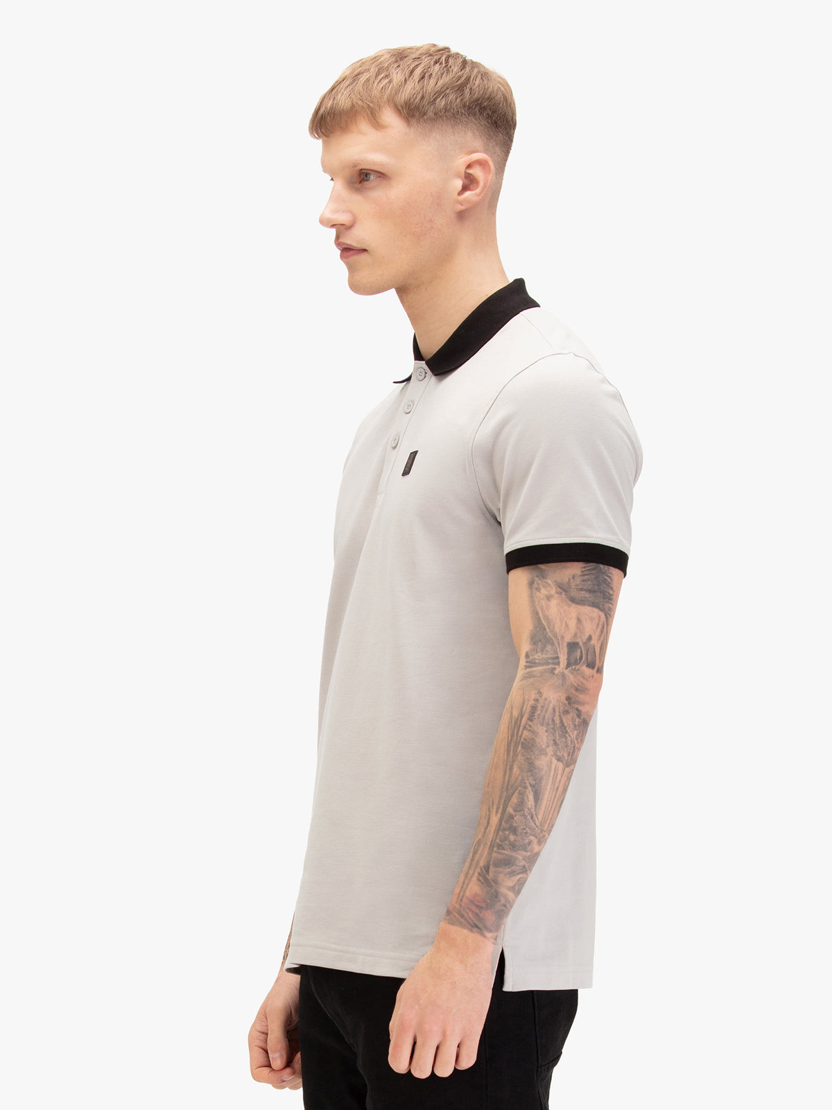 Men's grey polo shirt with polo collar, worn by a model, side view