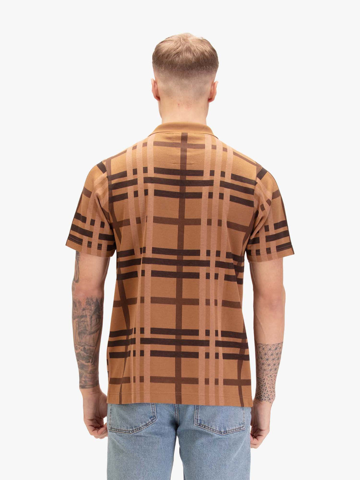 Men's orange polo shirt with polo collar, worn by a model, side view
