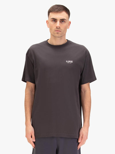 Men's relaxed-fit grey t-shirt with crew neck and short sleeves, worn by a model, front view