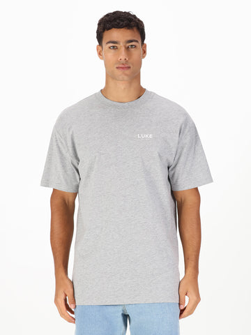 Men's relaxed-fit grey t-shirt with crew neck and short sleeves worn by a model - front view.