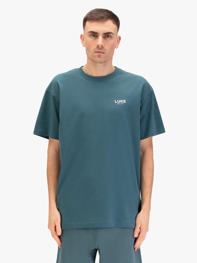 Men's relaxed-fit blue t-shirt with crew neck and short sleeves, worn by a model, front view