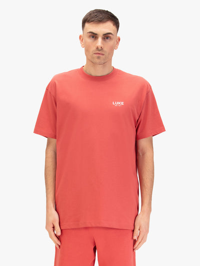 Men's relaxed-fit red t-shirt with crew neck and short sleeves, worn by a model, front view