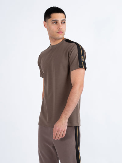 Men's brown t-shirt with crew neck and short sleeves worn by a model - front view.