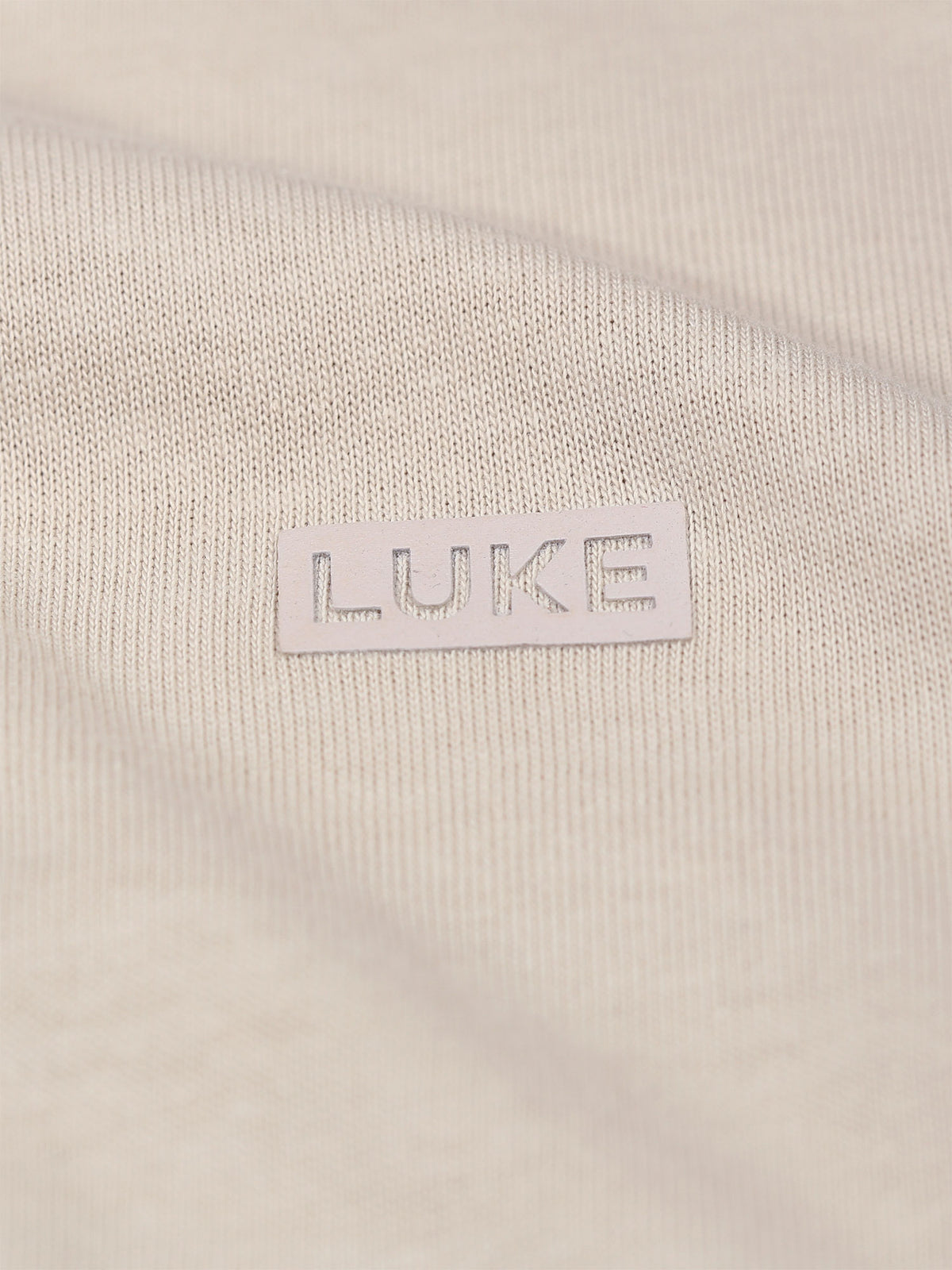 Men's beige t-shirt with crew neck and short sleeves worn by a model - side view.