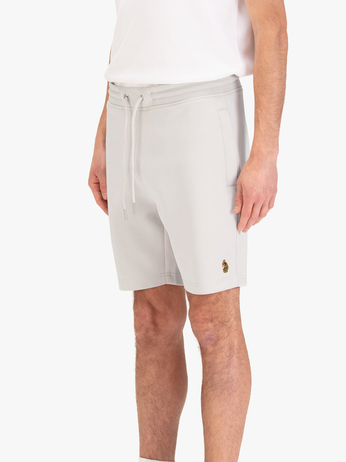 Men's grey shorts with drawstring waistband, worn by a model, side view