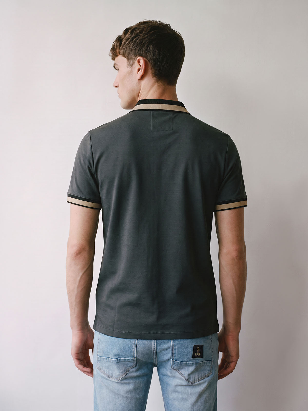 Back view of charcoal LUKE 1977 Makati pique polo shirt worn by model