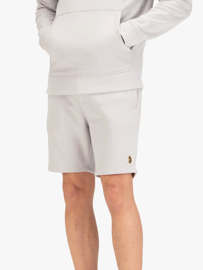 Men's grey shorts with drawstring waistband, worn by a model, front view