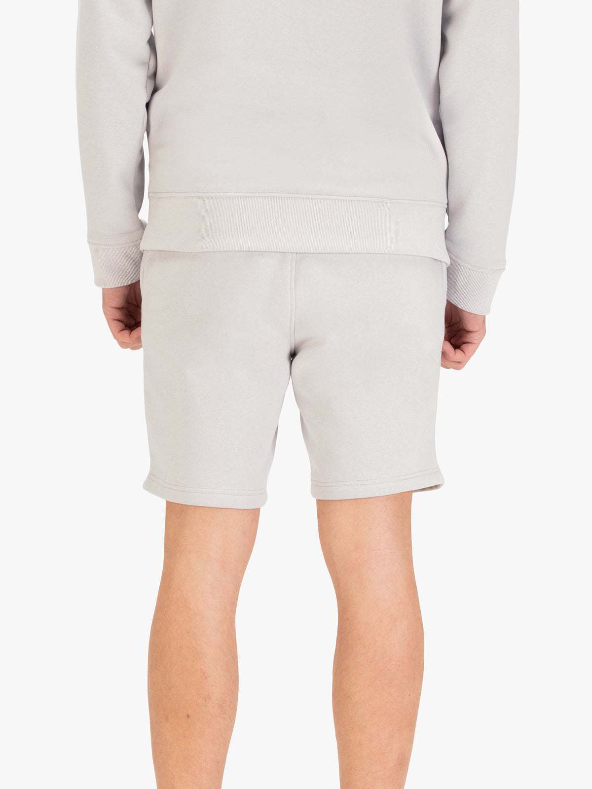 Men's grey shorts with drawstring waistband, worn by a model, back view