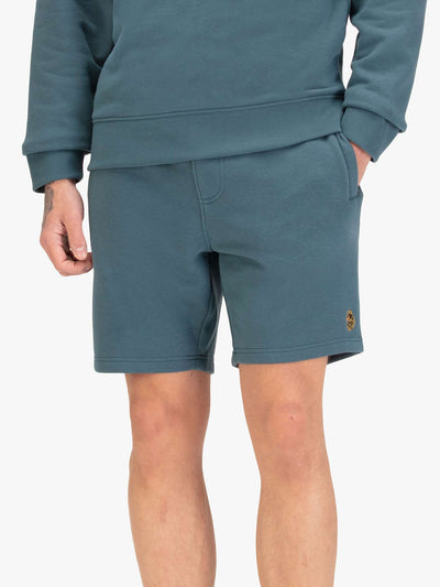 Men's blue shorts with drawstring waistband, worn by a model, front view