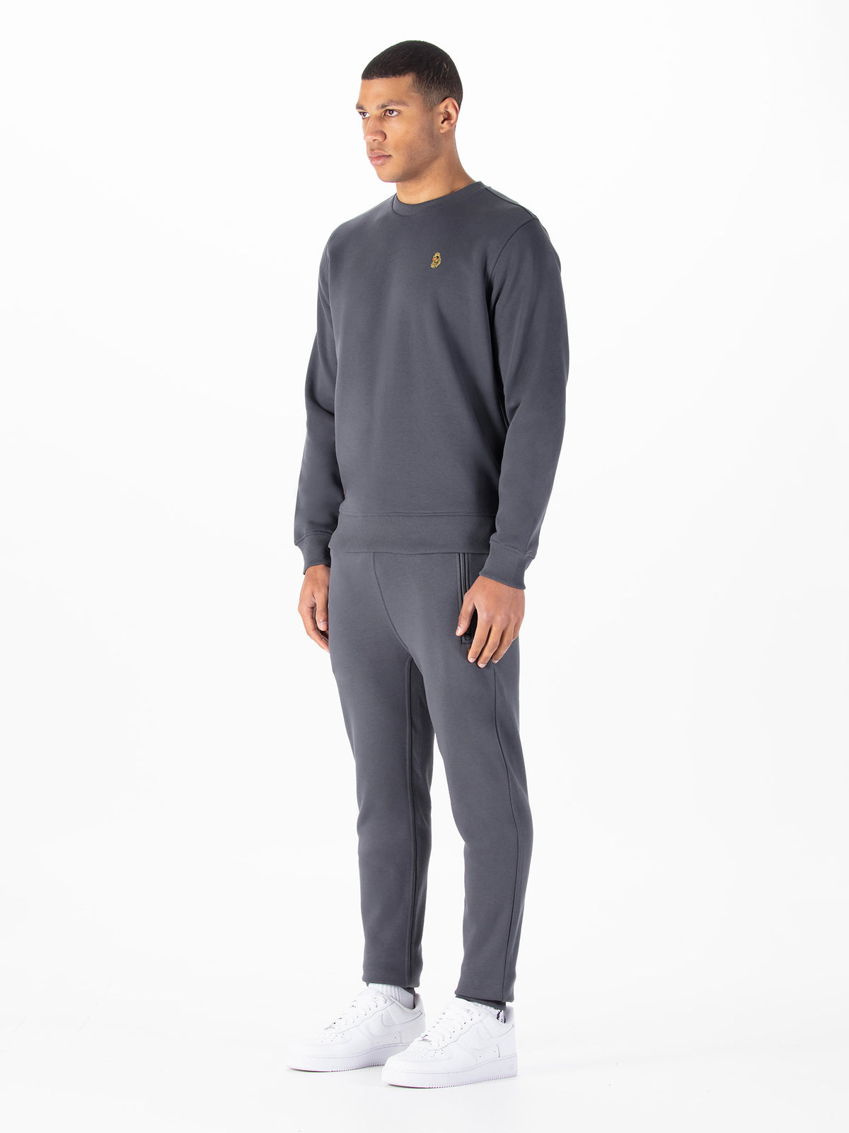 Men's grey tracksuit with crew neck sweatshirt and matching joggers.