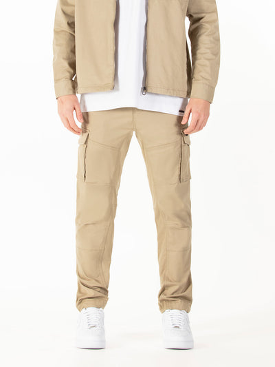 Men's beige cargo trousers with cargo pockets.
