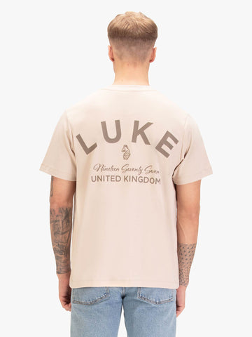 Men's relaxed-fit beige t-shirt with crew neck and short sleeves, worn by a model, back view